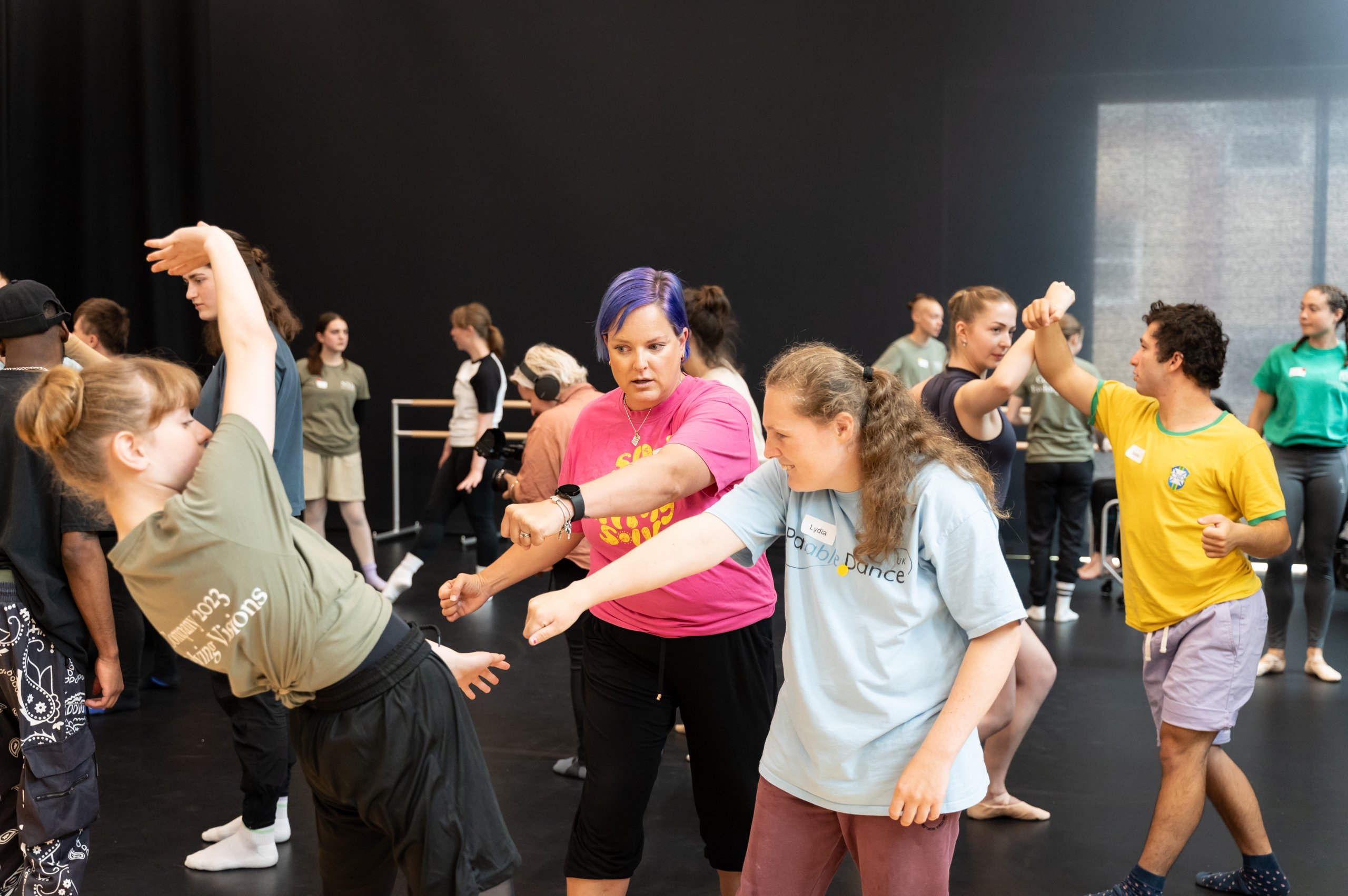 Whole company with fists clenched motioning towards one another. 